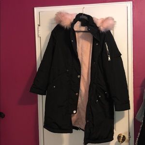 Long black  winter coat lined with pink faux fur.